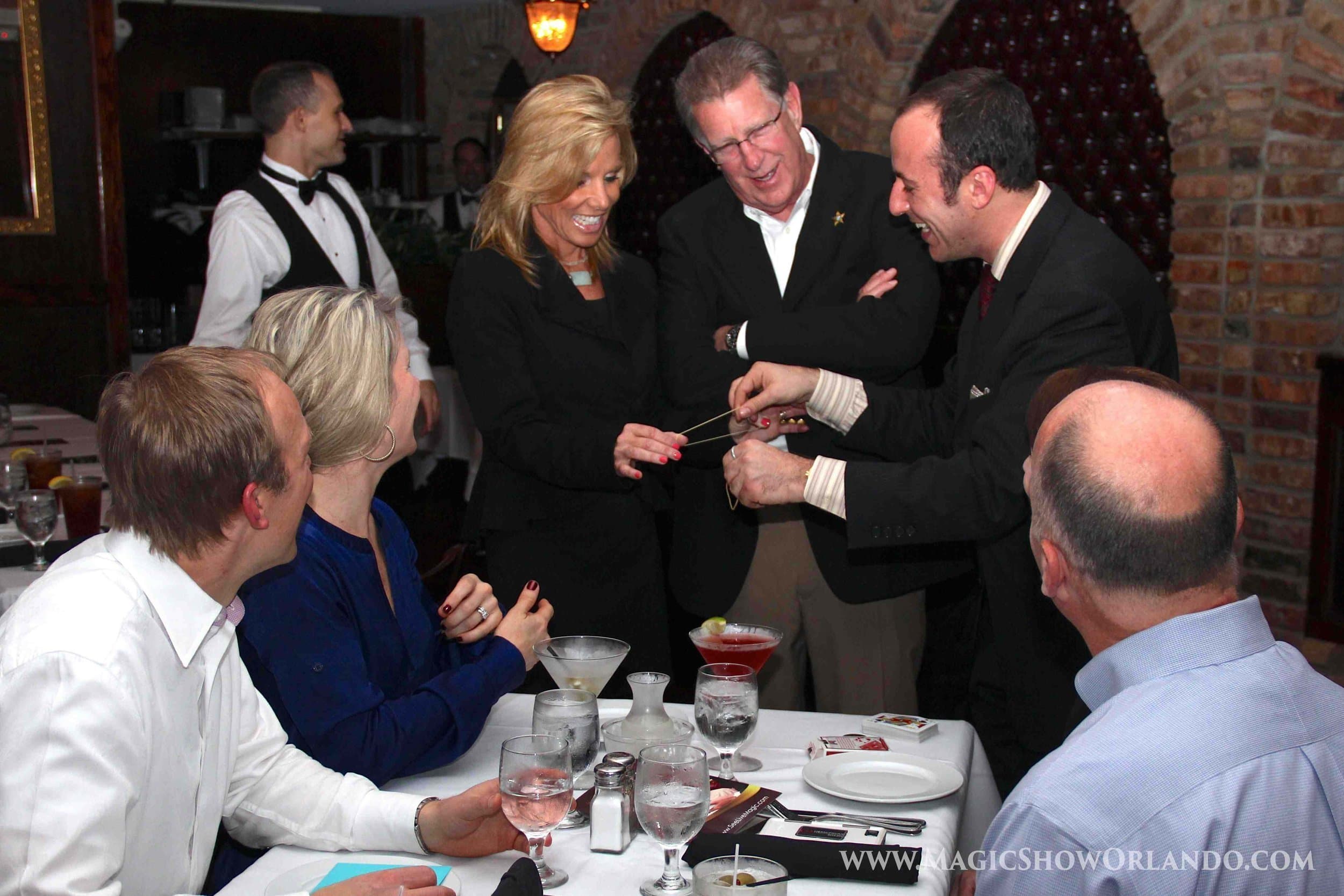 close-up magician performing card magic for a small group