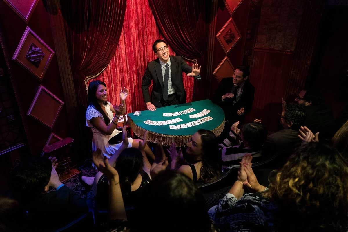 parlour magician performing for guests at a private event